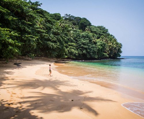 Person walking on the beach at Praia Boi on Príncipe Island